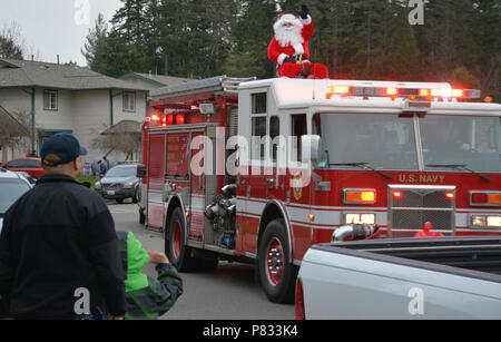 SILVERDALE, Wash. (Dec. 18, 2016) – Residents at Naval Base Kitsap (NBK) – Bangor family housing greet Santa Claus’ arrival on a Navy Region Northwest (NRNW) Fire and Emergency Services truck. Santa and his helpers delivered candy to NBK residents at Bangor and Jackson Park. Stock Photo