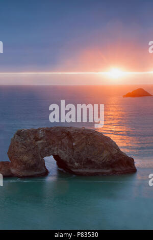 Oregon's  Arch Rock in Samuel H. Boardman State Scenic Corridor at sunset Stock Photo
