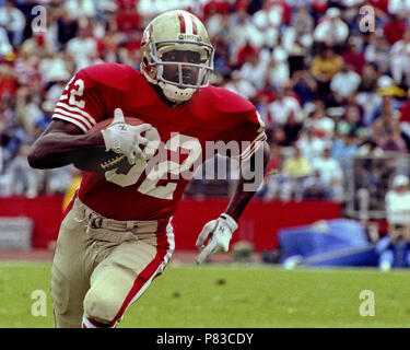 San Francisco 49ers' John Taylor (82) catches a tipped touchdown pass  thrown by quarterback Steve Young despite the defensive efforts of  Washington Redskins' AJ Johnson (47) during the first quarter of their