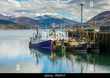 Fishing boats in the harbour at Ullapool on Loch Broom, with the Beinn Dearg mountain range behind.  Ullapool, Sutherland, Scotland, UK Stock Photo