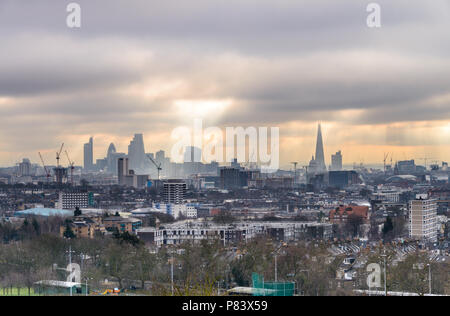 View from Parliament Hill at Hampstead Heath towards the London skyline with The Shard and Gherkin set against a dramatic sky with rays of sun Stock Photo