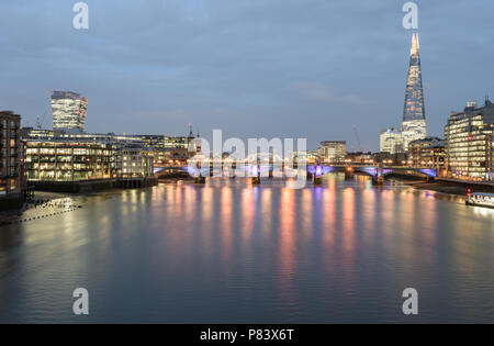 Night time view from Millennium Footbridge to London Bridge and Tower Bridge with The Shard on the right and the Walkie Talkie building on the left Stock Photo