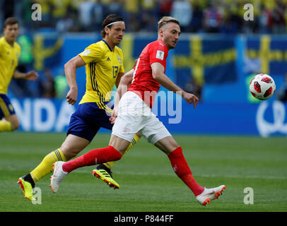 SAINT PETERSBURG, RUSSIA - JULY 3: Gustav Svensson (L) of Sweden national team and Josip Drmic of Switzerland national team vie for the ball during the 2018 FIFA World Cup Russia Round of 16 match between Sweden and Switzerland at Saint Petersburg Stadium on July 3, 2018 in Saint Petersburg, Russia. (MB Media) Stock Photo