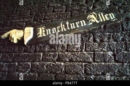 Knockturn Alley sign in the Wizarding World of Harry Potter. The sign points the way with a long arm and pointing hand, leading to the darker HP world Stock Photo