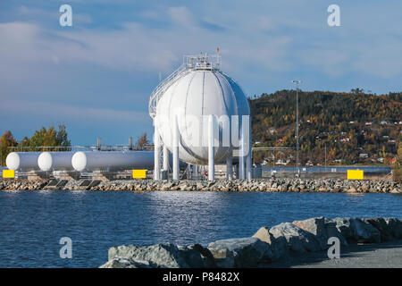 White spherical gas holder stands on sea coast in Stjordal, Norway Stock Photo