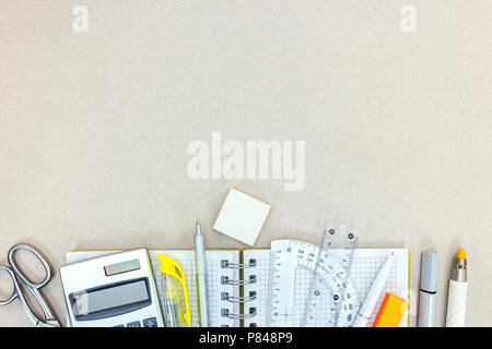 back to school concept. various stationary items on grey desk surface Stock Photo