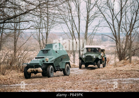 Russian Armored Soviet Scout Car BA-64 Of World War II And Four-wheel Drive Army Truck GAZ-67 Car Of World War II Parking In Autumn Forest Stock Photo