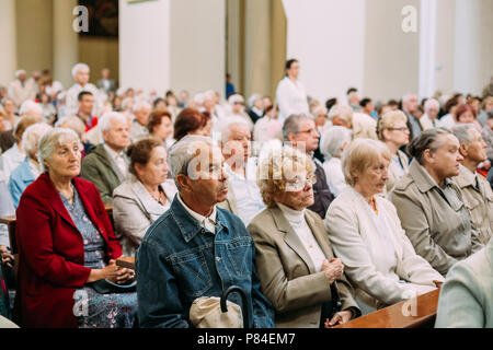 Vilnius, Lithuania - July 6, 2016: People Parishioners pray in Cathedral Basilica of Saints Stanislaus and Vladislaus during celebration of Statehood  Stock Photo