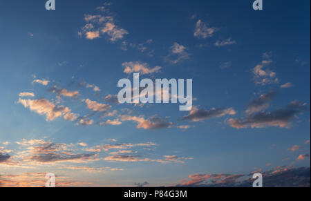 Sunset sky with some sparse clouds Stock Photo