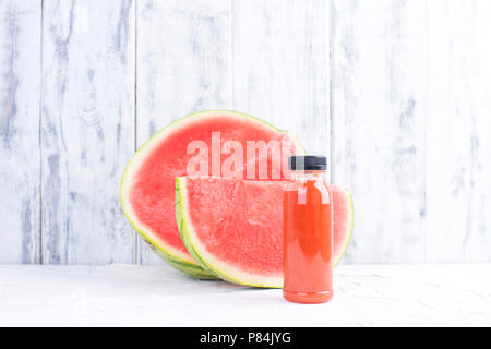 Ripe juicy watermelon and fresh juice in a plastic bottle. Copy space Stock Photo