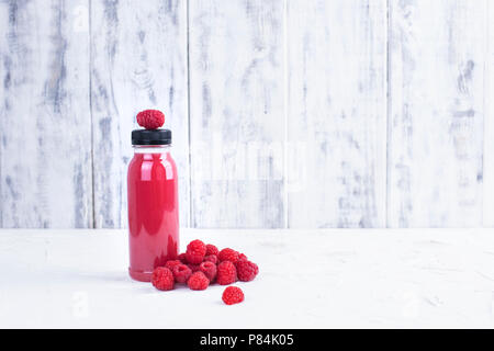 Fresh raspberry and juice in a plastic bottle. Detox. White background. Copy space Stock Photo