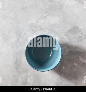 Blue porcelain bowl isolated on stone gray background, flat lay Stock Photo