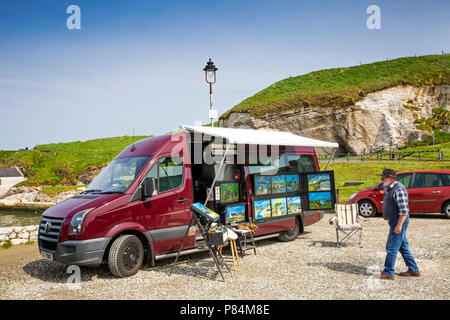 UK, Northern Ireland, Co Antrim, Ballintoy Harbour, amateur artist displaying work at motorhome mobile art gallery Stock Photo