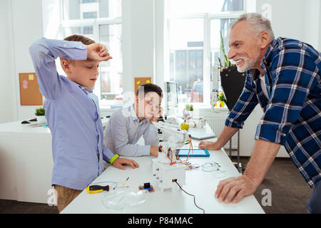 Nice tired boy touching his forehead Stock Photo