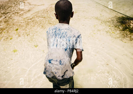 African child in search of seafood in the ocean Stock Photo