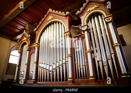 The organ in the church made of wood old and restored Stock Photo