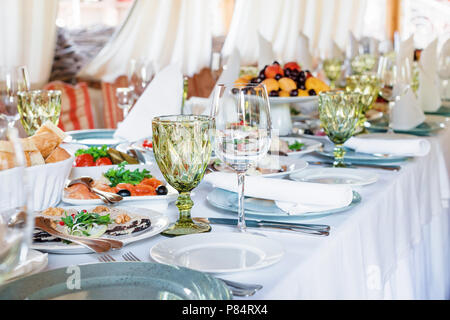 Table decorations for holidays and wedding dinner. Table set for holiday, event, party or wedding reception in outdoor restaurant Stock Photo