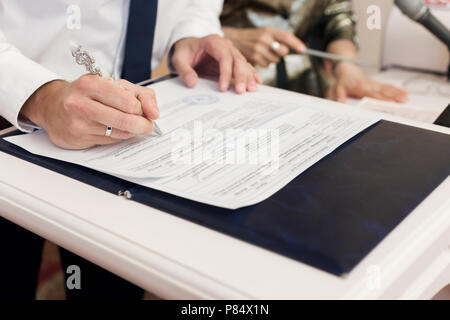 Man leaving signatures registration of marriage close up Stock Photo