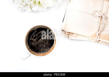 White coffee mug placed near postal cards Stock Photo