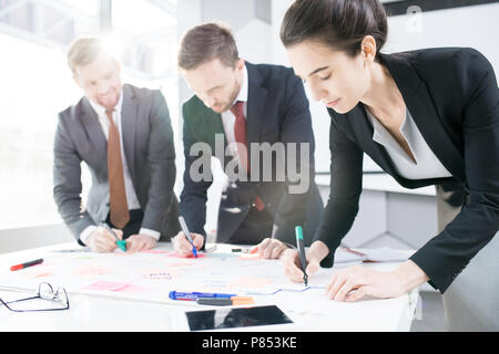 Team of Business People Collaborating on Project Stock Photo