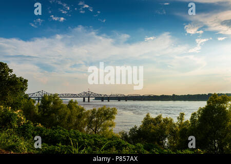 View of the Mississippi River with the Vicksburg Bridge on the background at sunset; Concept for travel in the USA and visit Mississippi Stock Photo