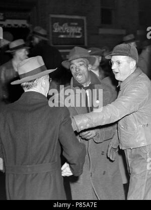 An argument ensues at a picket line in front of a meatpacking plant in Kansas City, MO, ca. 1946. Stock Photo