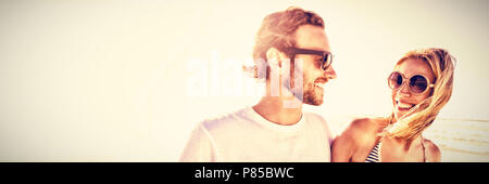 Happy young couple wearing sunglasses at beach Stock Photo