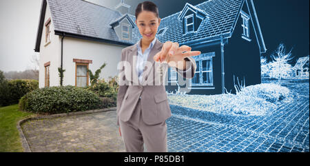 Composite image of portrait of a smiling businesswoman holding a key Stock Photo