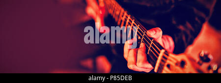 Mid-section of man playing guitar Stock Photo