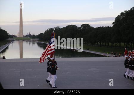 Marines with the U.S. Marine Corps Color Guard march the National Ensign and the U.S. Marine Corps Battle Colors across the parade deck during the Tuesday Sunset Parade at the Lincoln Memorial, Washington D.C. June 12, 2018, June 12, 2018. This year is the first year Barracks Marines are hosting Tuesday Sunset Parades at the Lincoln Memorial. The guest of honor for the parade was Secretary of the Interior Ryan Zinke and the hosting official was Robert D. Hogue, counsel for the commandant of the Marine Corps. () Stock Photo