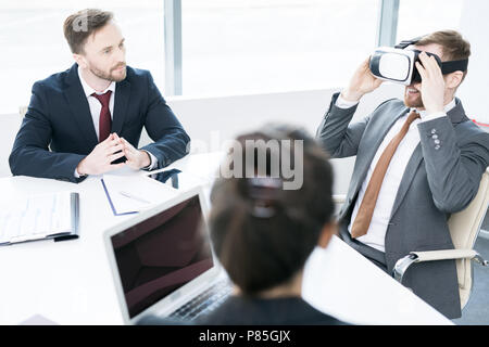 Businessman Using VR in Meeting Stock Photo
