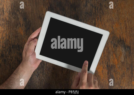 Digital tablet computer with isolated screen in male hands close up, top view Stock Photo