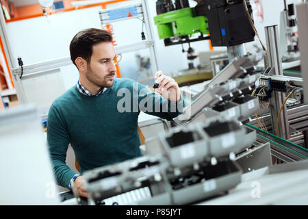 Young student of electronics working on project Stock Photo