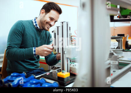 Young student of electronics working on project Stock Photo