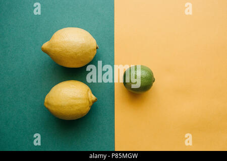 Mix of lemons and lime on a colored background. Stock Photo