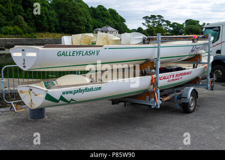 two coastal rowing boats mounted on a trailer in west cork, Ireland. Stock Photo