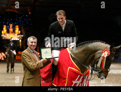 Marc Houtzager riding Sterrehof's Tamino accepts the award from Richard de Leyser - Managing Director Rolex UK, after winning the 7th round of The Rolex FEI World Cup Jumping Season 2012/2013 presented by H&M at London Olympia. 22 December 2012 June 2012 --- Image by © Paul Cunningham Stock Photo