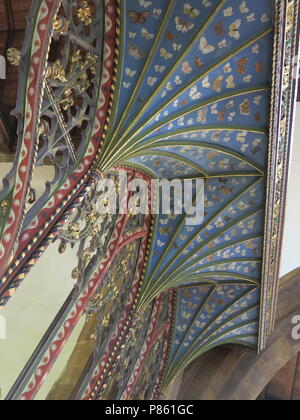 The 15th century rood screen, with butterfly decoration added in 1935 by a local artist, features inside the Saxon church at Earls Barton. Stock Photo