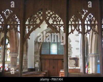 A view looking back through the 15th century rood screen from the chancel to the nave inside the Saxon church, All Saints, at Earls Barton Stock Photo