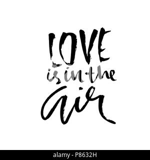 Love is in the air. Handdrawn calligraphy for Valentine day. Ink illustration. Modern dry brush lettering. Vector illustration. Stock Vector