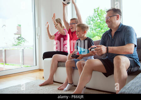 Grandparents, their son and grandson are watching world soccer championship and emotionally ill for the national team Stock Photo