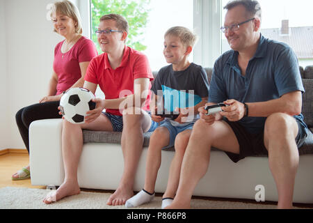 Grandparents, their son and grandson are watching world soccer championship and emotionally ill for the national team Stock Photo