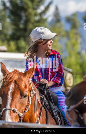 Attractivr, young girl, sitting in the saddle, on a trail ride adventure. Stock Photo