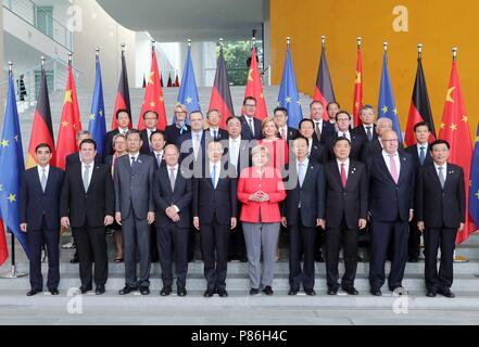 Berlin, Germany. 9th July, 2018. Chinese Premier Li Keqiang (5th L, front) and German Chancellor Angela Merkel (5th R, front) pose for a group photo with representatives attending the fifth round of intergovernmental consultations, co-chaired by the two leaders, in Berlin, Germany, July 9, 2018. Credit: Liu Weibing/Xinhua/Alamy Live News Stock Photo