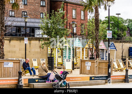 A family relax at the Quayside Seaside pop-up beach by the River Tyne in Newcastle, UK. July 2018. Stock Photo