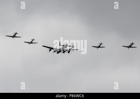 London, UK. 10th July 2018. The Royal Air Force's Battle of Britain Memorial Flight pass over London, with the Avro Lancaster, Two Hawker Hurricanes and three Supermarine Spitfires during the RAF100 Flypast Credit: James Hancock/Alamy Live News Stock Photo