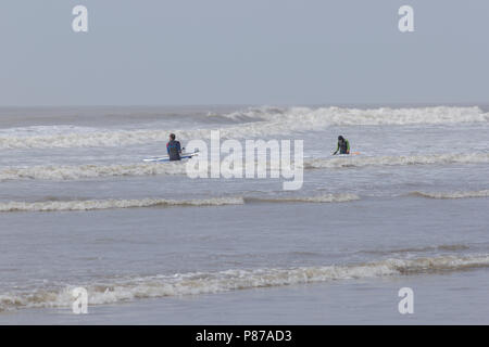 Porthcawl, South Wales UK. 14th April 2018. UK Weather: Surfers brave the waves at Porthcawl, South Wales on a sunny day. Stock Photo