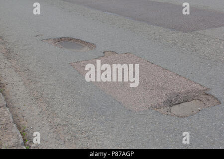 Pot holes in Carterton, Oxfordshire UK. 13th May 2018. UK Weather: Pot holes in West Oxfordshire, multiple potholes on the streets of Oxfordshire. Stock Photo