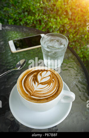 Cup of latte art Coffee in coffee shop. Latte art Coffee is the type of coffee is an art. Stock Photo