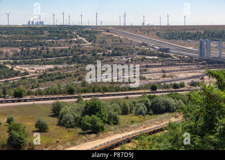 Open pit mine with conveyor belts transporting coal to powerplant Stock Photo